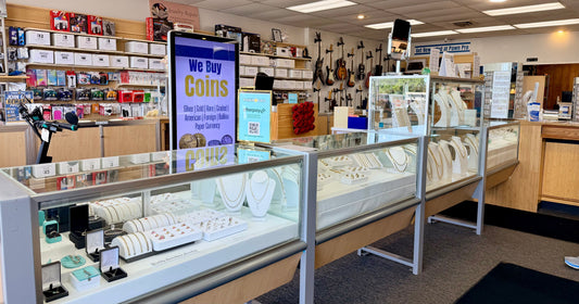 Clean, Bright, Organized Jewelry Display with Glimpses of Guitars & Game Systems in the Background